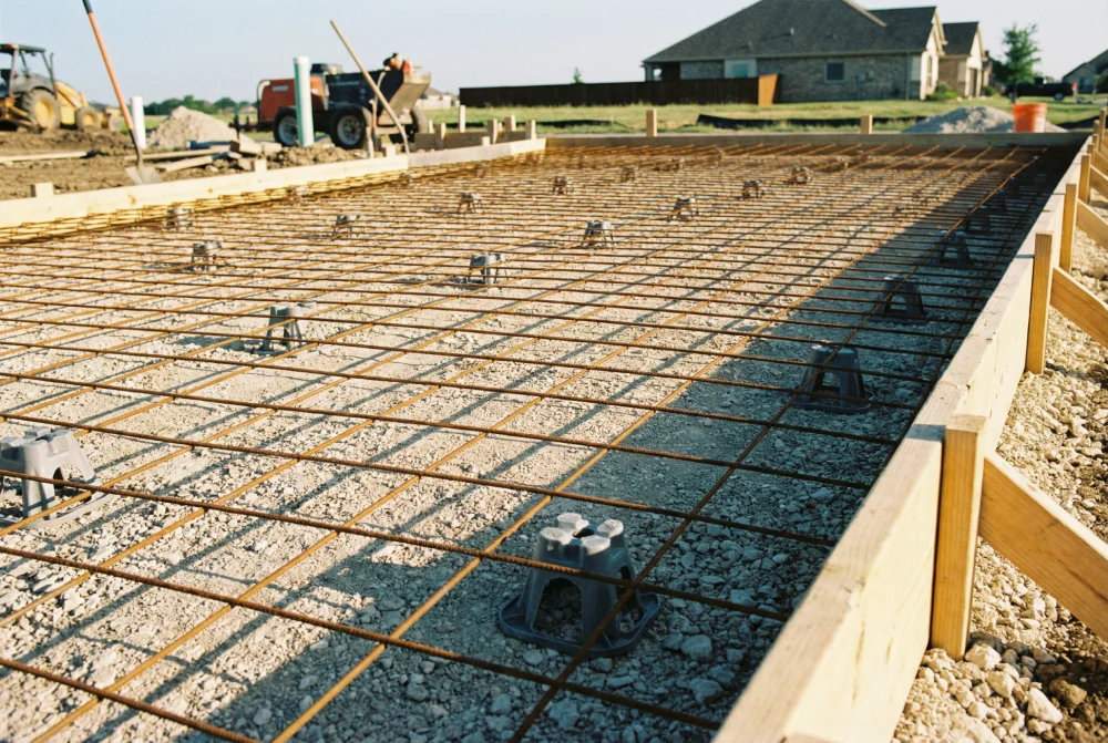 Wire mesh reinforcement positioned inside concrete driveway forms before the pour